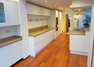 white kitchen, oatmeal quartz worktop and oak flooring