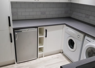 small white kitchen with black handles and white metro tiles