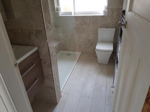 Hotel style bathroom with large walk in shower with rain head